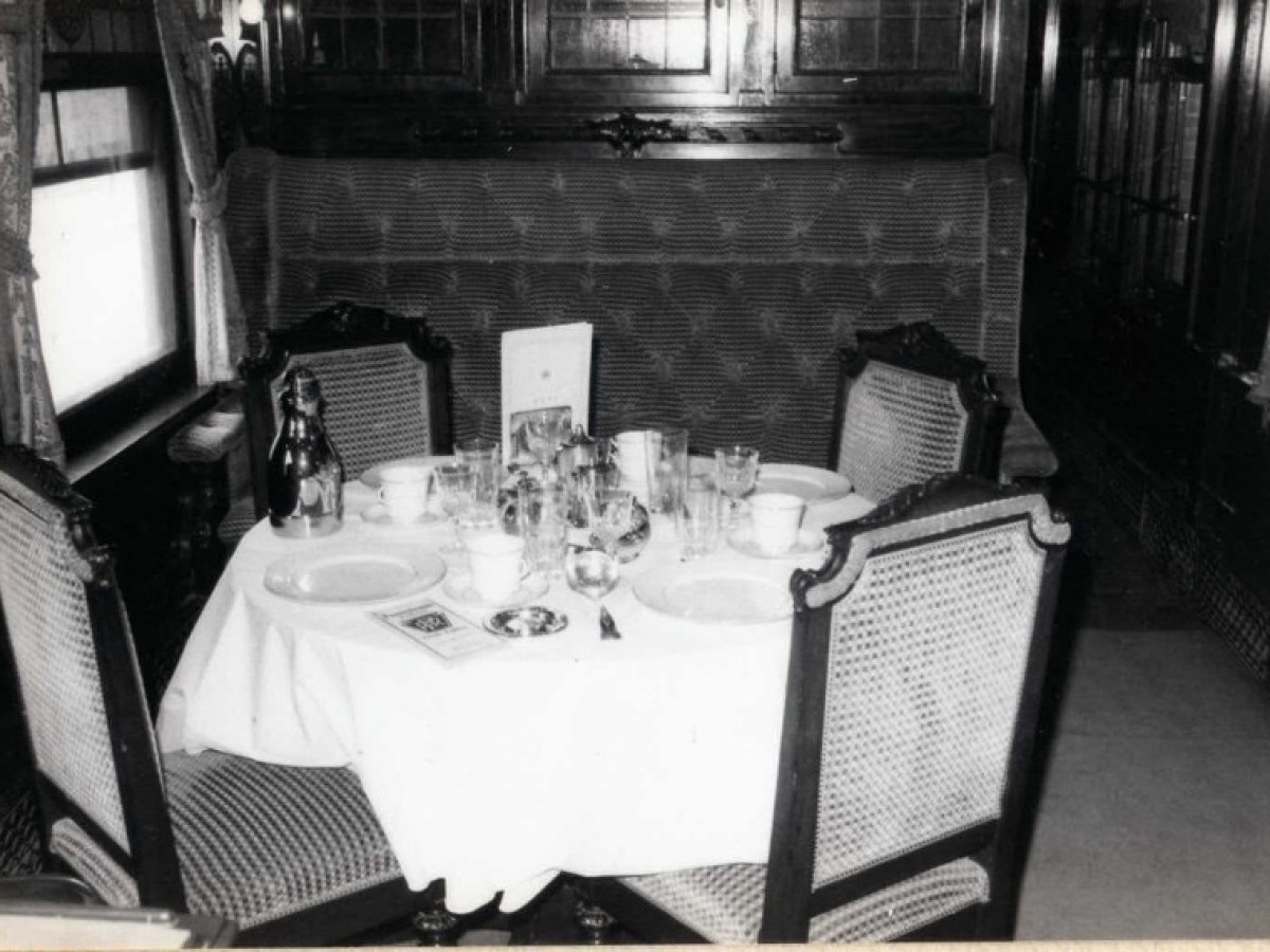 a kitchen with a sink and a chair in a room