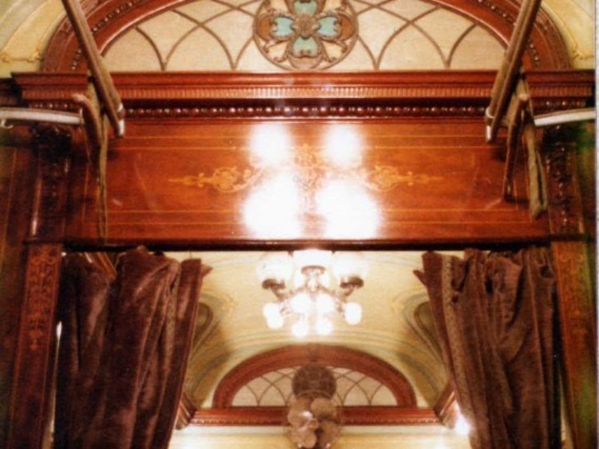 a pizza sitting on top of a wooden chair