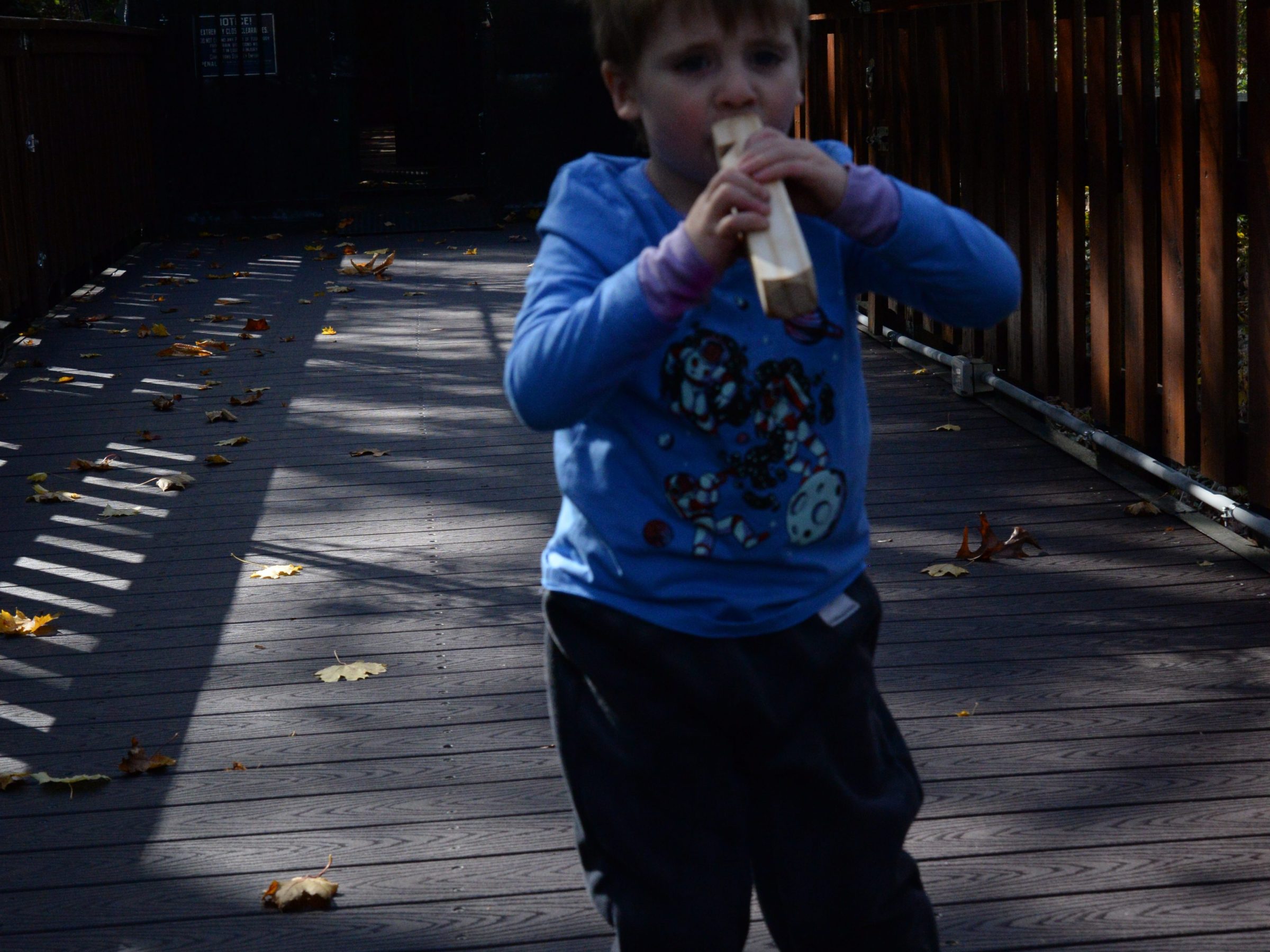 a young boy riding a skateboard down a sidewalk
