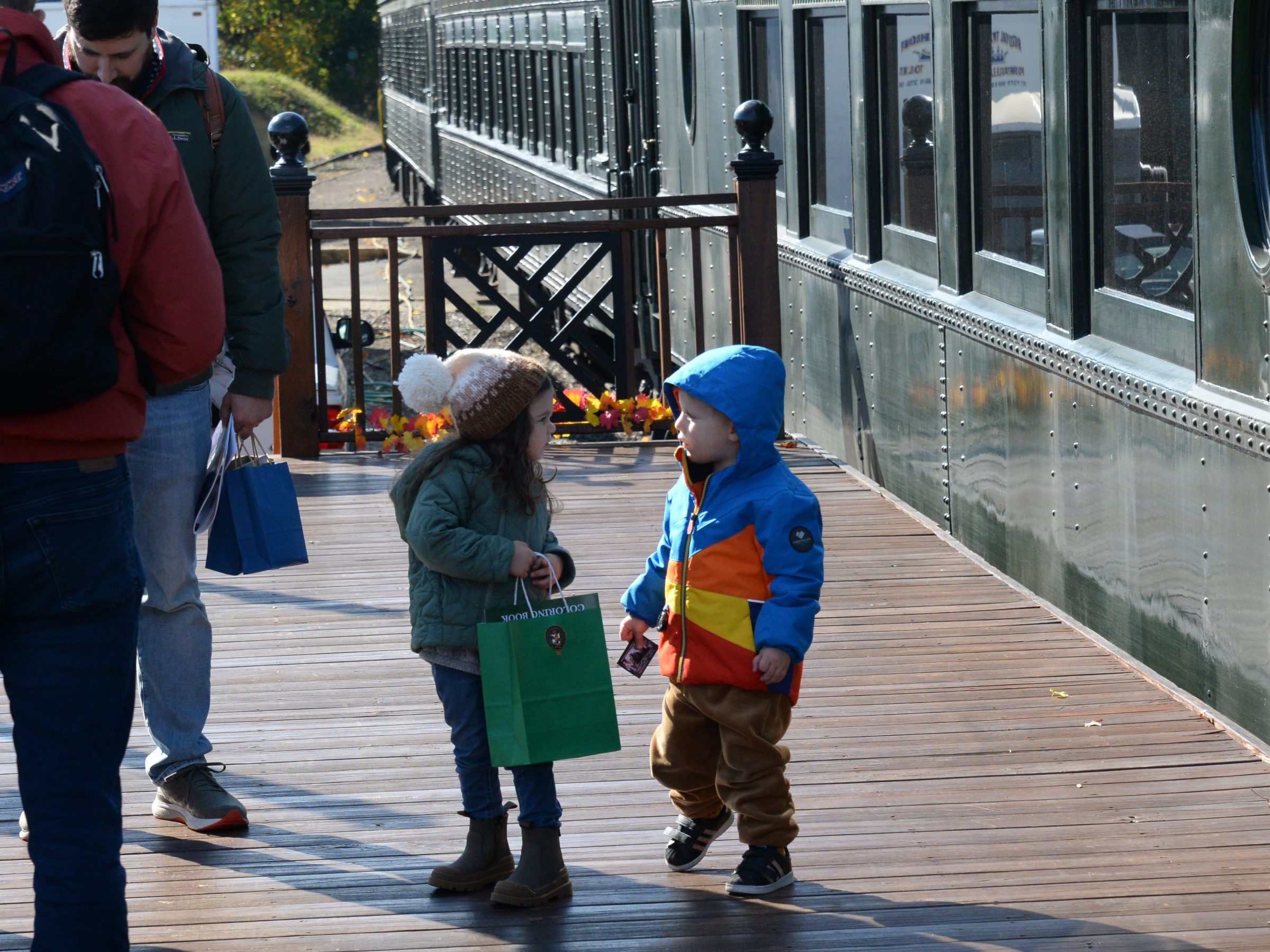 a group of people standing next to a train