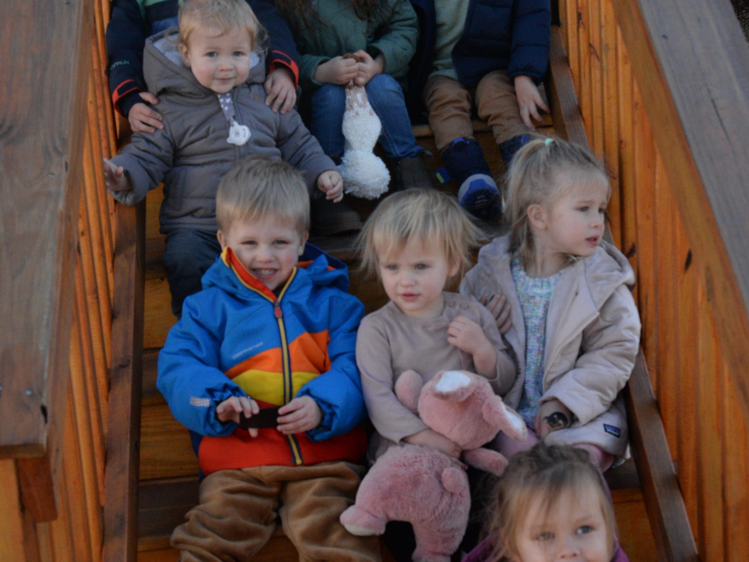 a group of young children sitting next to a child