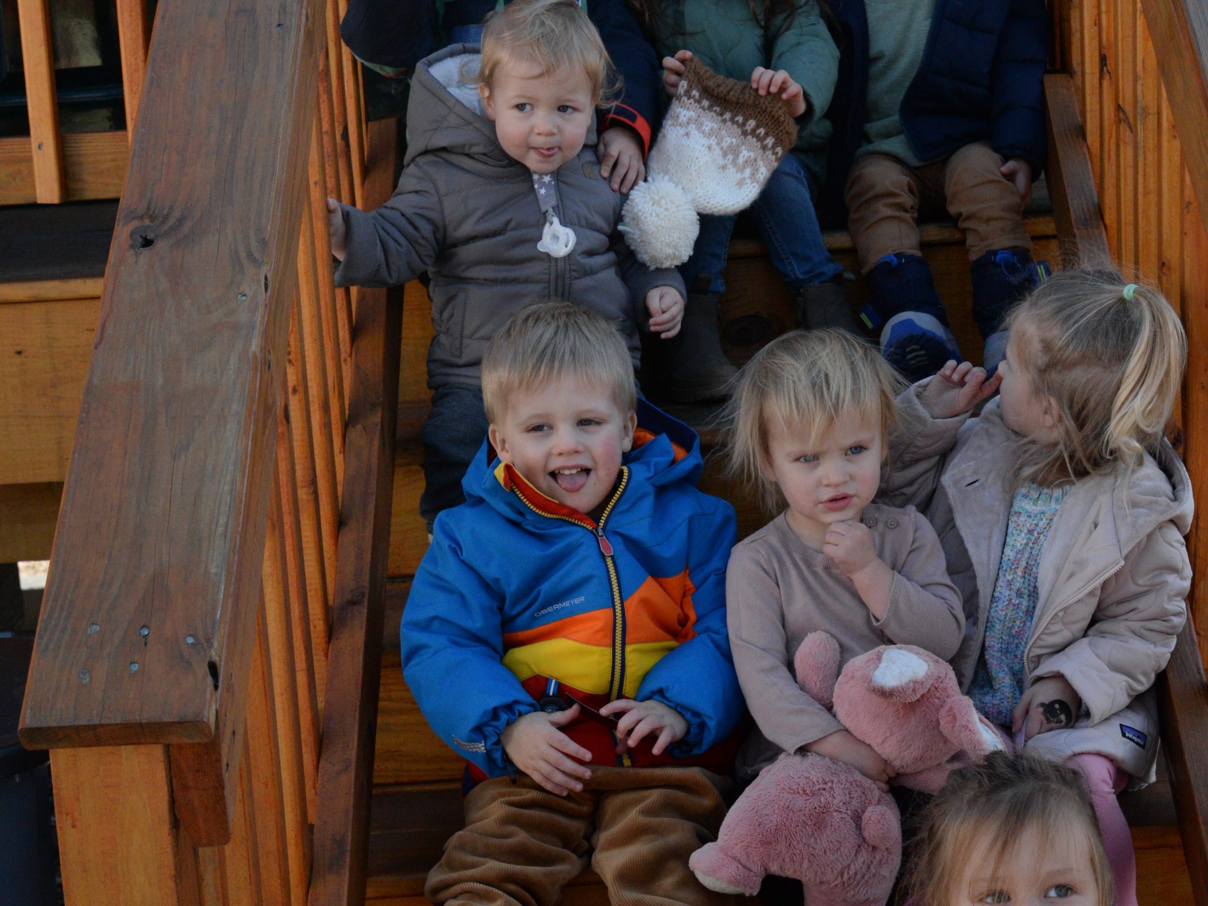 a group of young children sitting next to a child