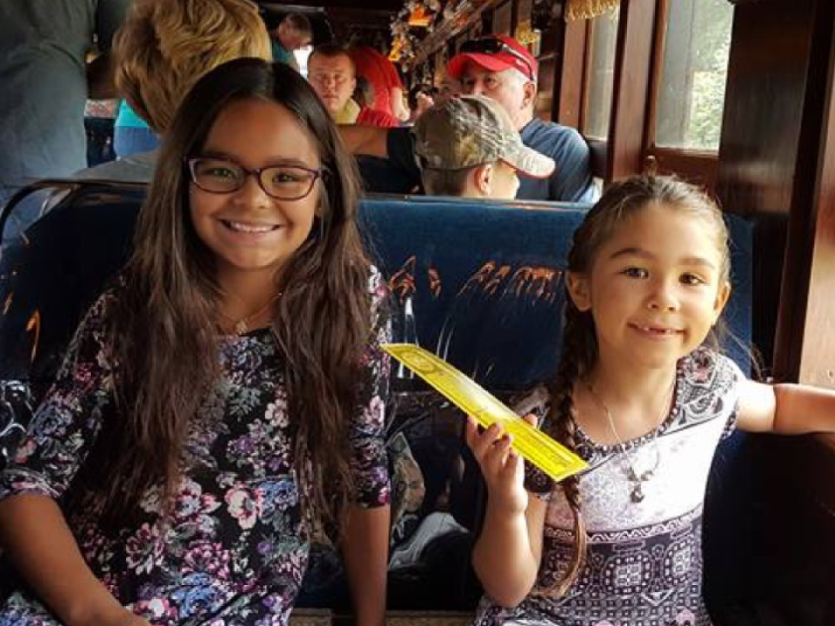 a girl sitting on a table