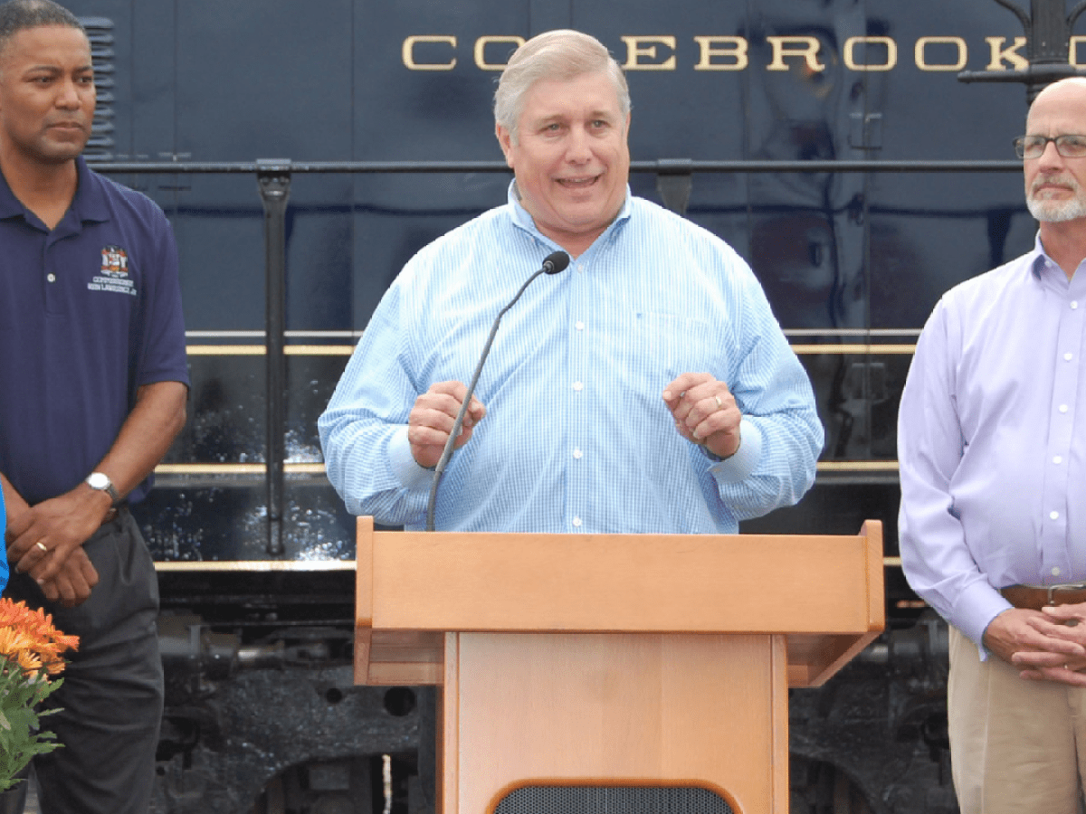 Christian Leinbach et al. standing in front of a building