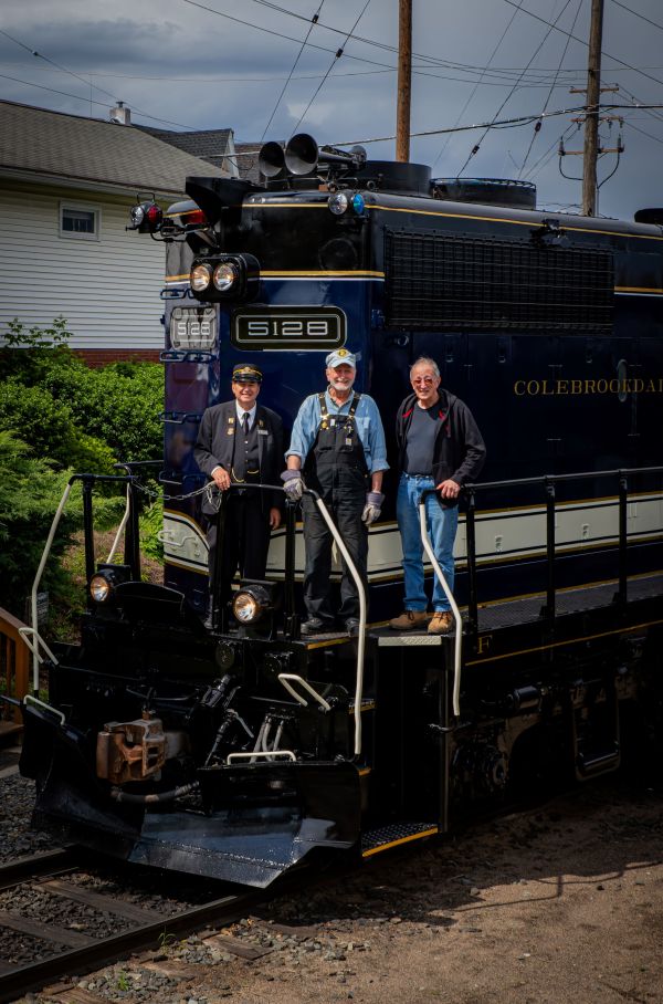 a group of people standing in front of a truck